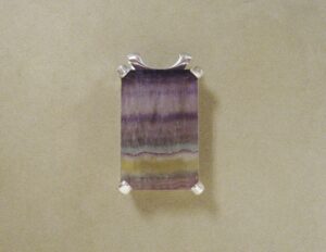 large emerald shaped gemstone in white gold