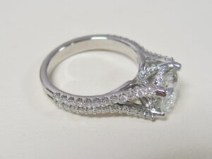 white gold ring with large diamond and many smaller accent diamonds