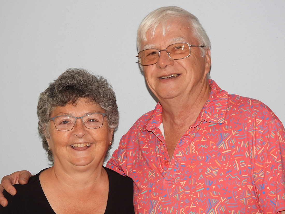 Robert and Lynne Grant standing side by side. Robert with is arm around Lynne's shoulders